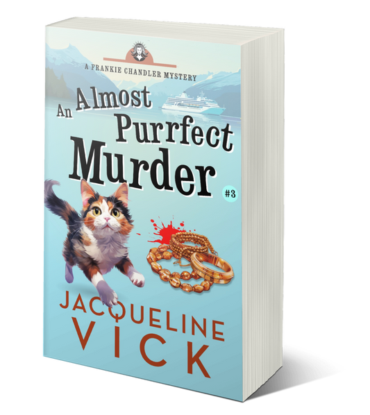 A light blue paperback cover with a calio cat and a pile of jewelry with bloodstains. An Almost Purrfect Murder, a Frankie Chandler Mystery by Jacqueline Vick. 